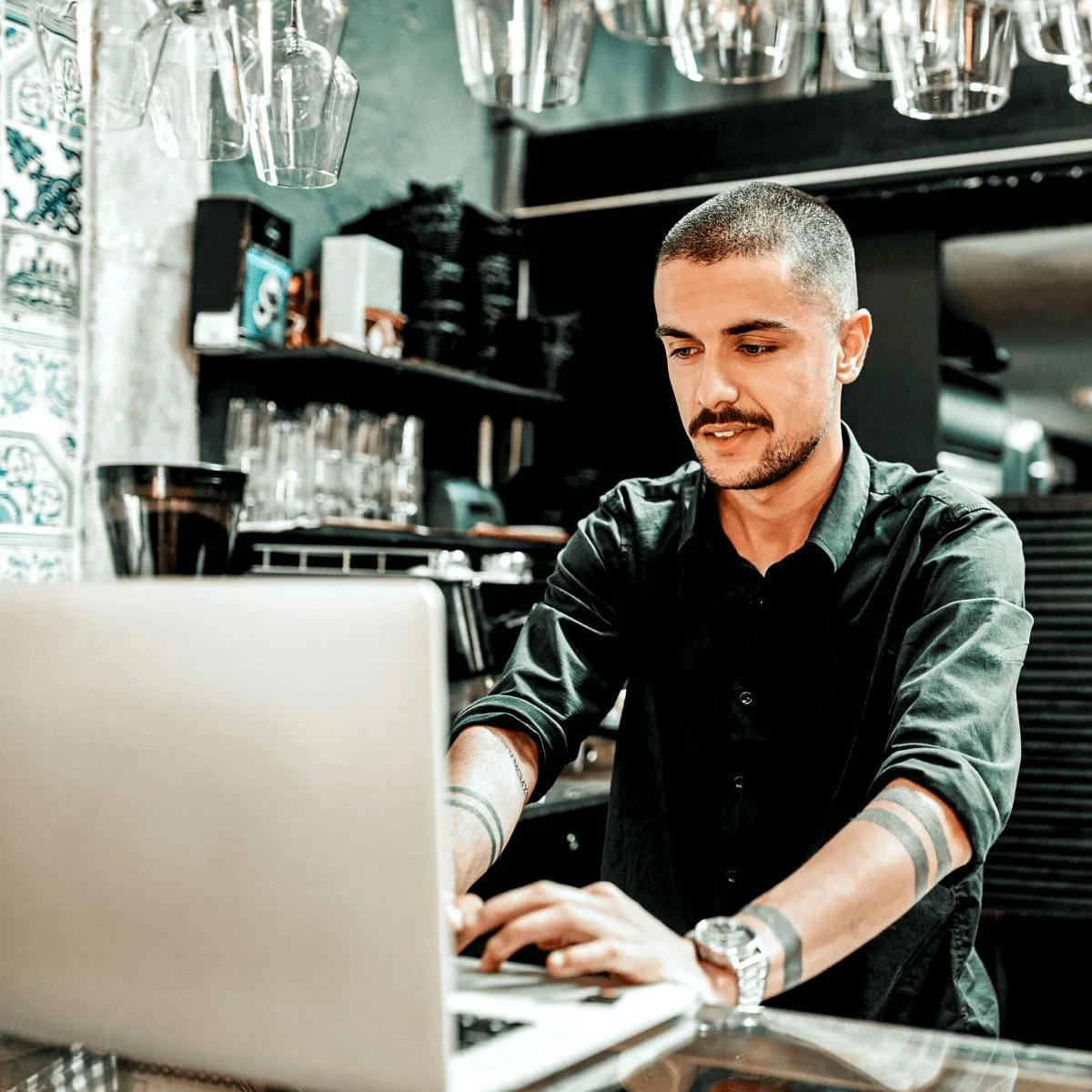 Photo of a man working on his laptop